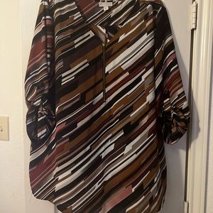 Multi warm colors with zipper front and button up sleeves or wear long.